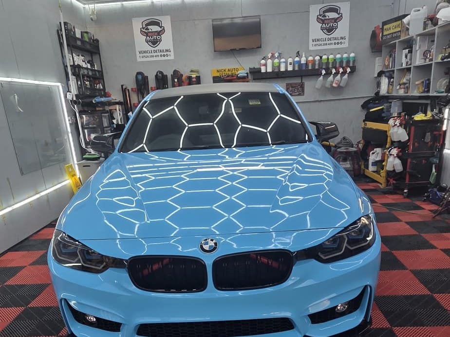 The Dock Road studio in Connah's Quay: a BMW under the hexagon lights on the chequered floor